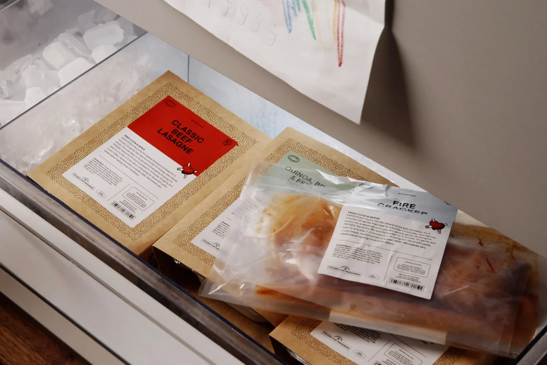 Dinner Ladies meals neatly stacked in a freezer drawer.