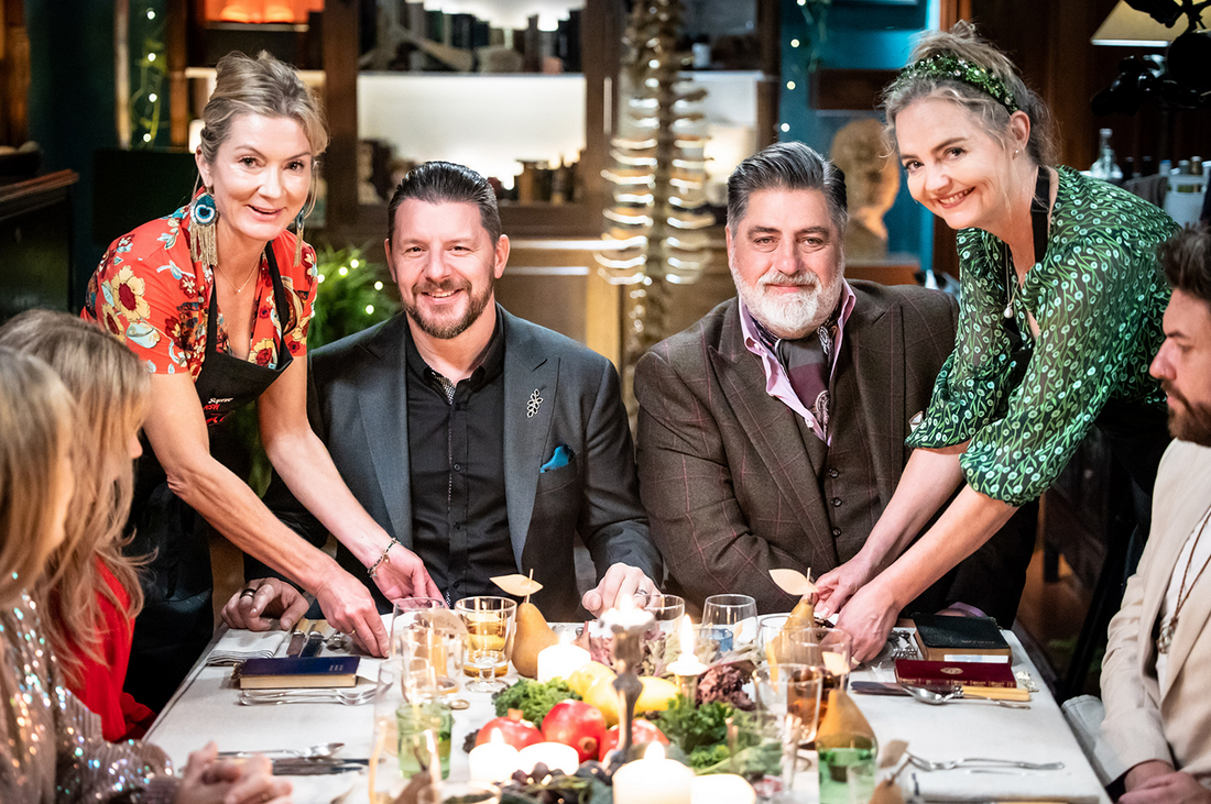 Sophie and Katherine with judges Manu and guests at their MKR 2022 Instant Restaurant ‘Hearth’, sharing a festive dinner table.
