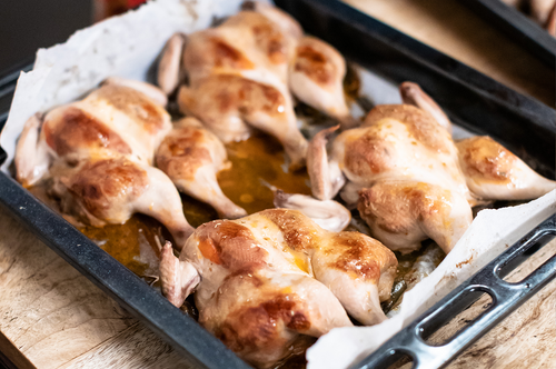 Roast spatchcock baked golden in a tray, ready to serve with rich flavour.