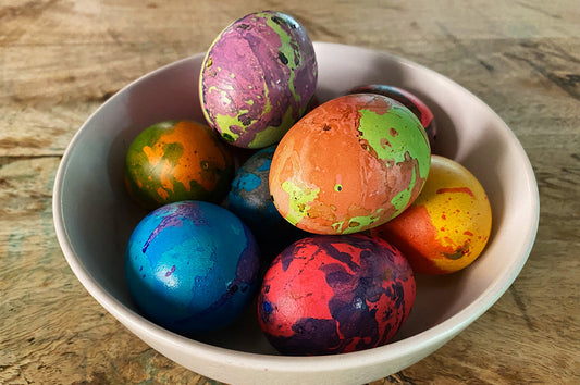 Bowl of colourful hand-dyed marble easter eggs.