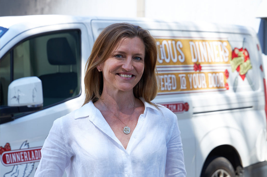 Sarah Boswell, Menu Director at The Dinner Ladies, smiling in front of a branded delivery van.