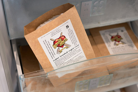Dinner Ladies frozen meal pack stored neatly in a home freezer drawer.