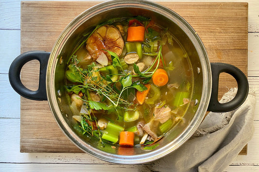 overhead image of vegetable stock in a pot.