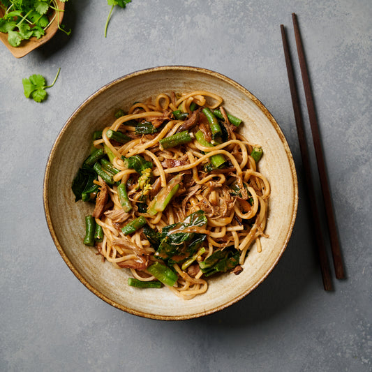 Udon noodles with shredded duck and Asian greens