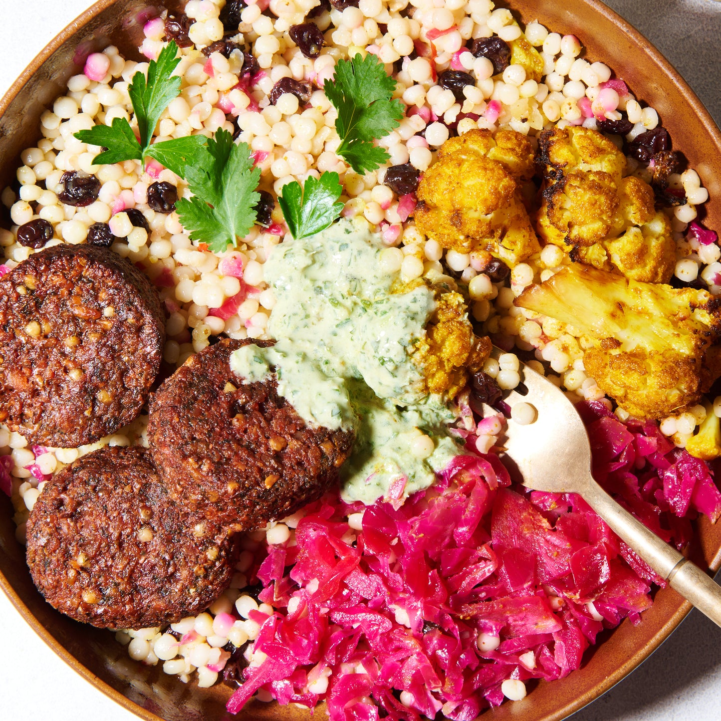 Beetroot falafel bowl with green tahini close up