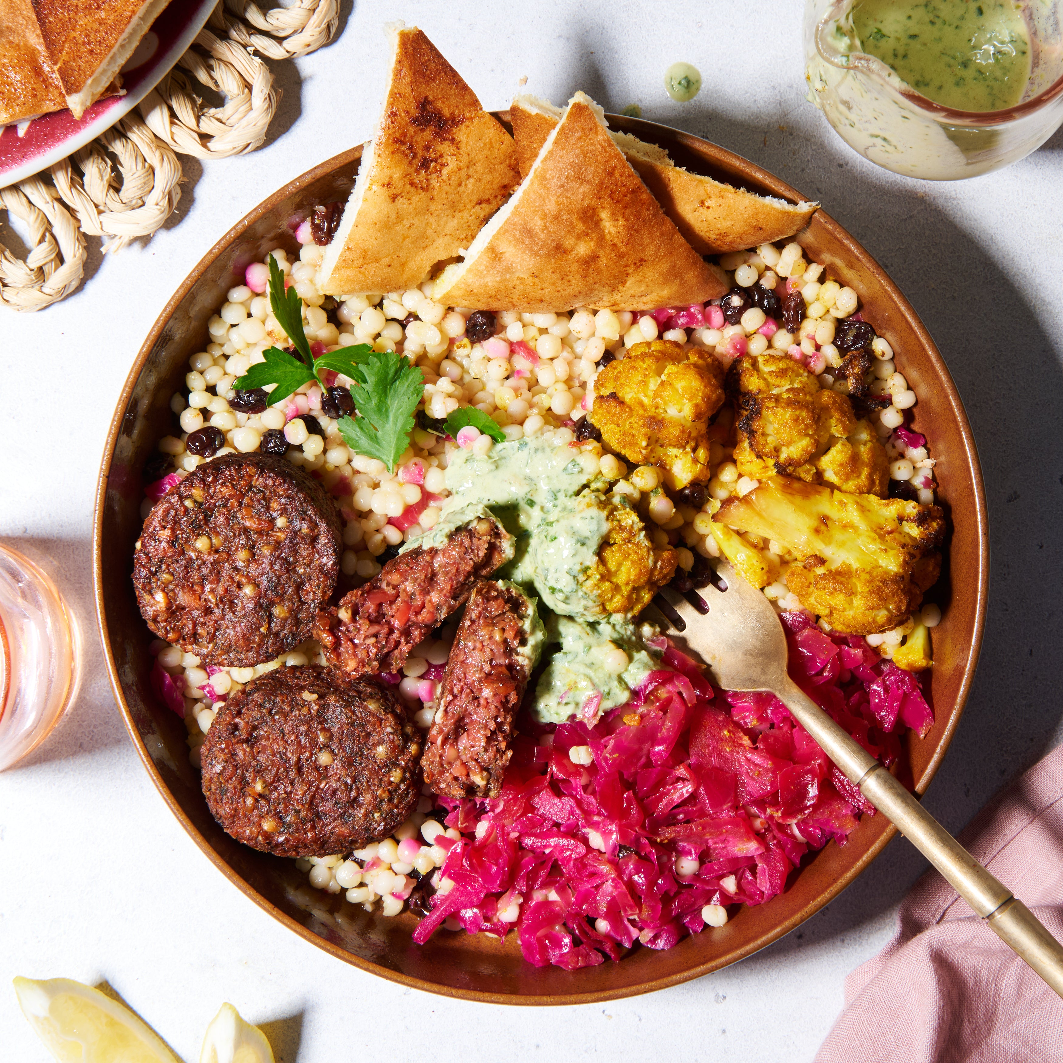 Beetroot falafel bowl with green tahini and pita bread