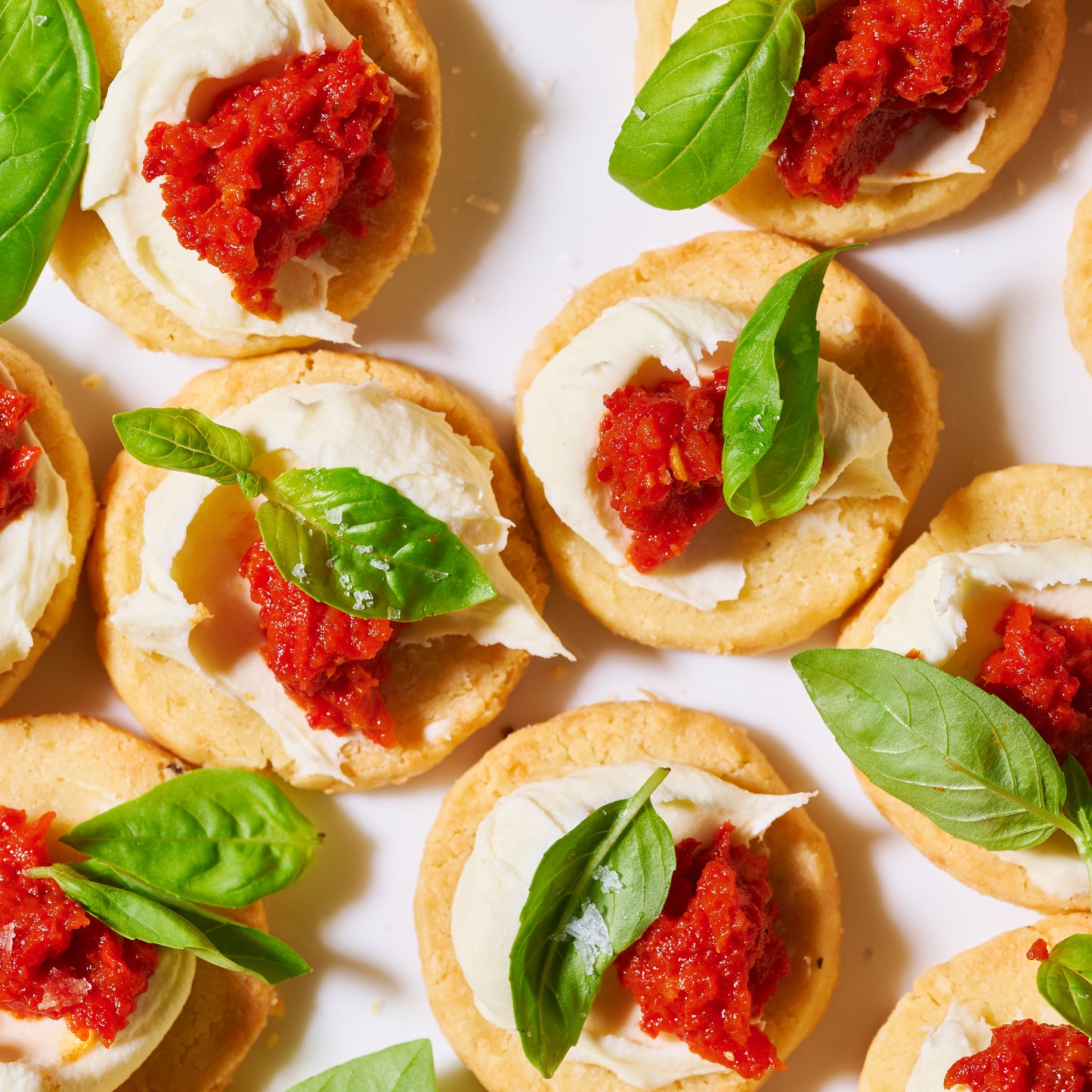 Christmas canapé Bake-at-home parmesan biscuits with red capsicum tapenade and mascarpone macro