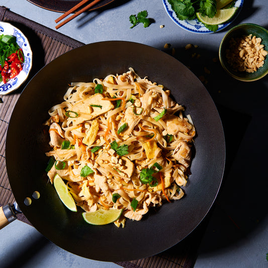 chicken tad thai in a wok