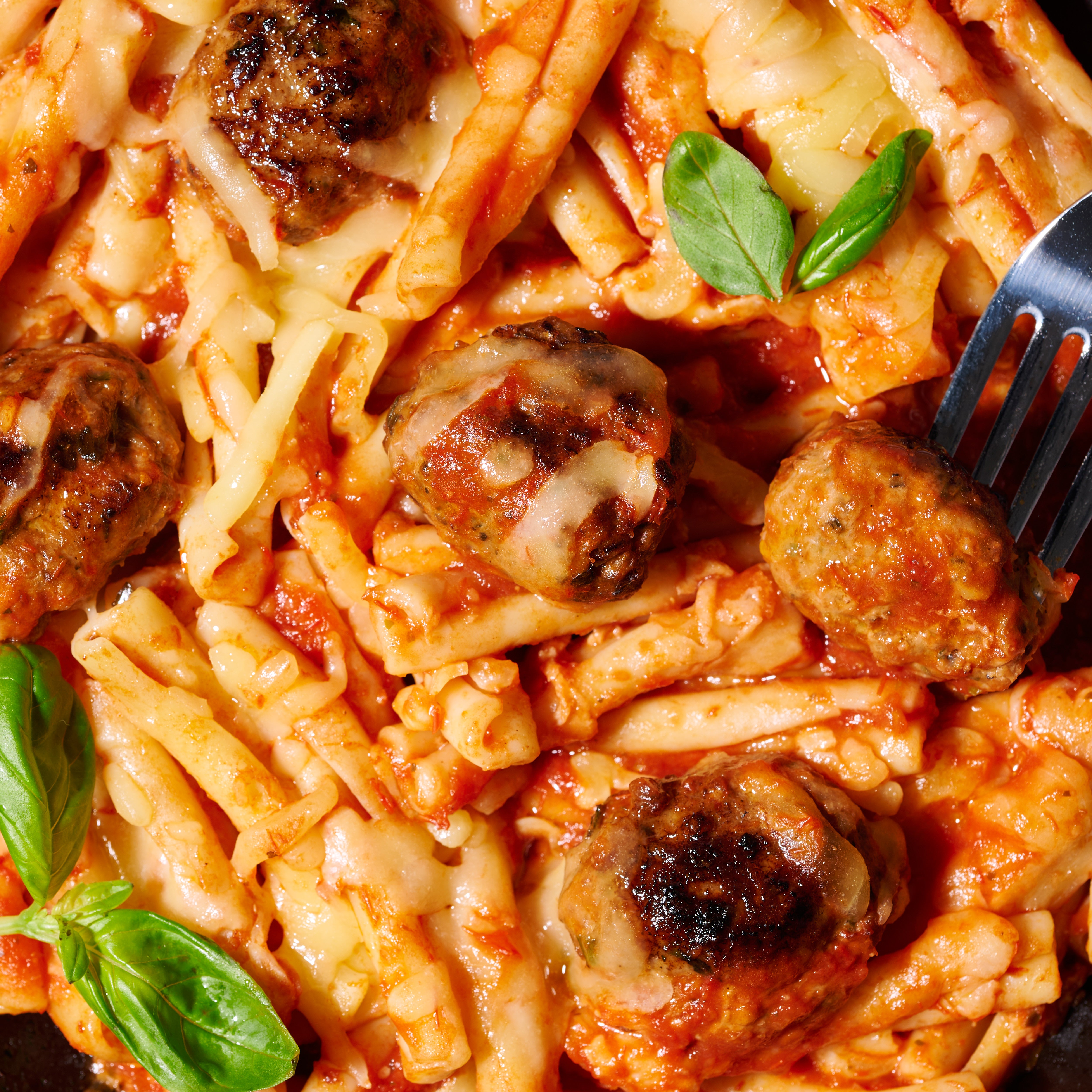 Casarecce with meatballs and mozzarella close up
