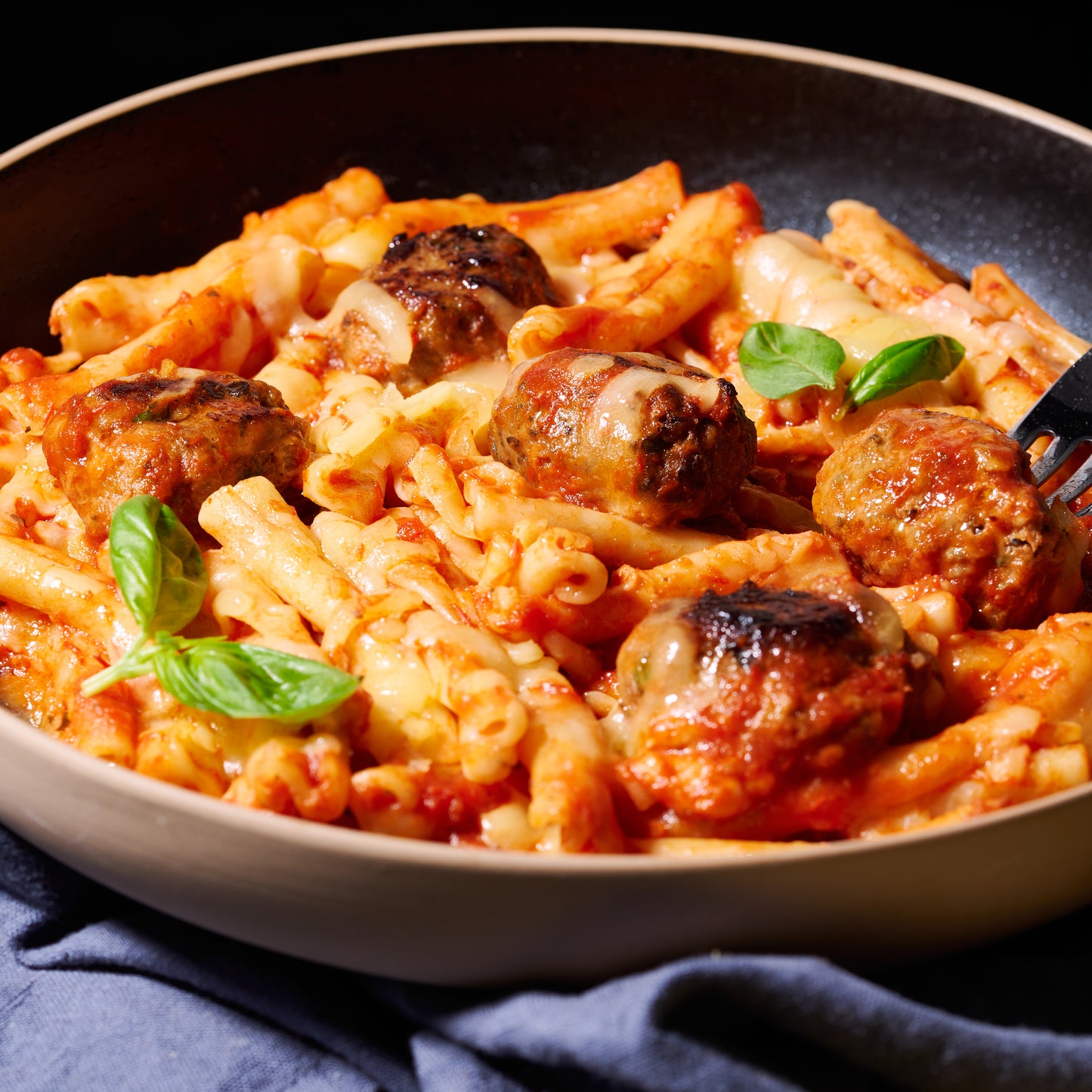 Casarecce with meatballs and mozzarella on a plate