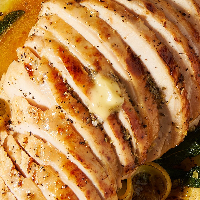 Citrus brined free range turkey breast with sage and honey butter close up