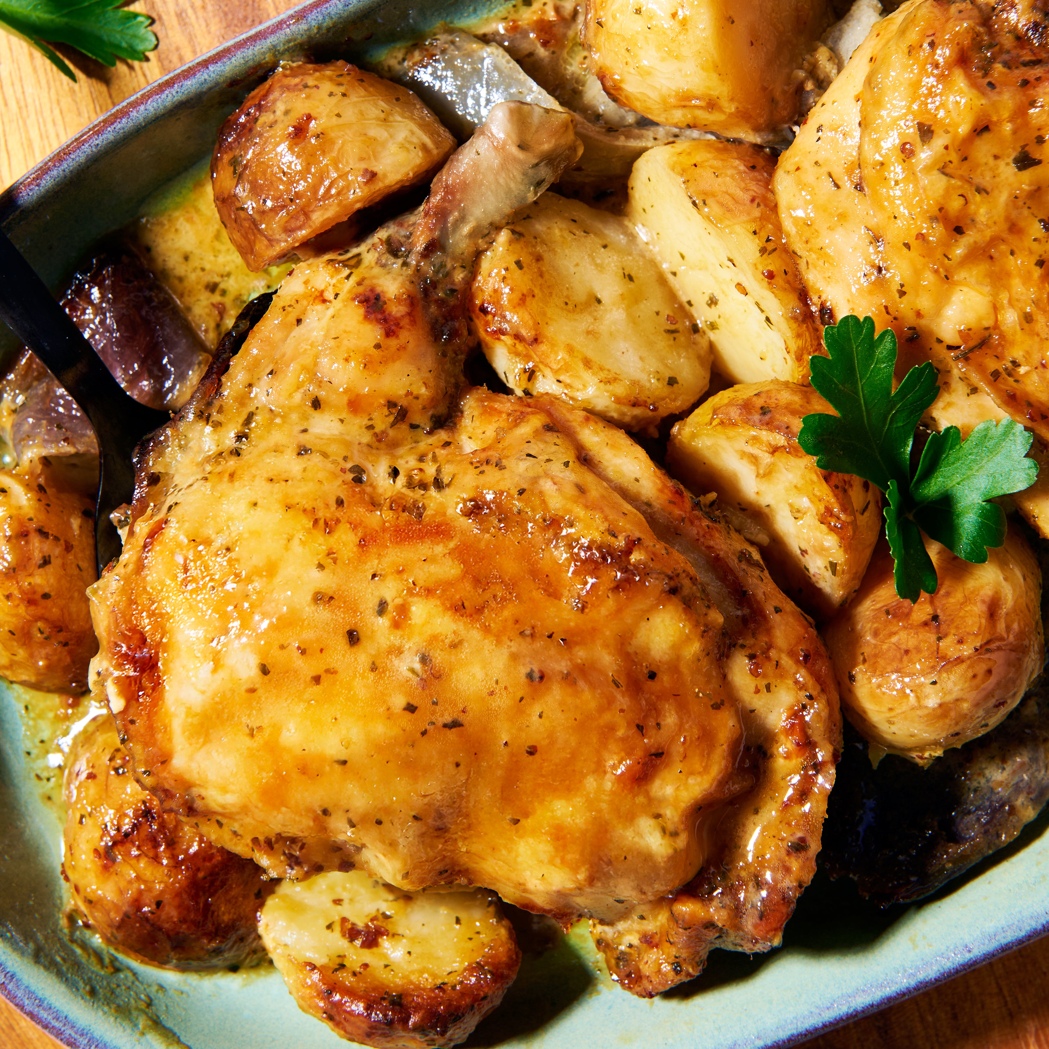 Close-up of Herby Lemon Chicken with golden roast potatoes in a French-style mustard tarragon sauce, garnished with parsley.