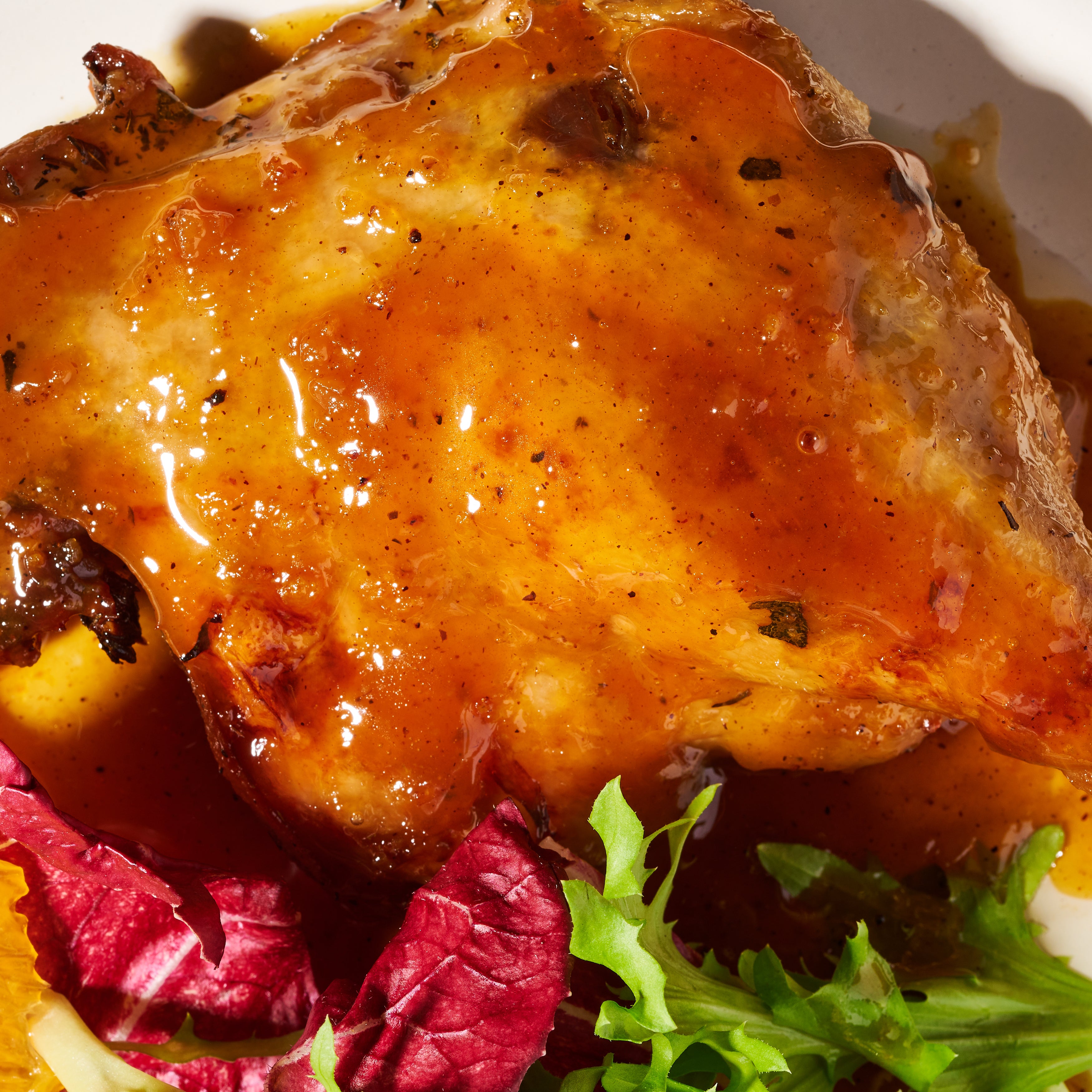 Duck confit with citrus and maple glaze close up