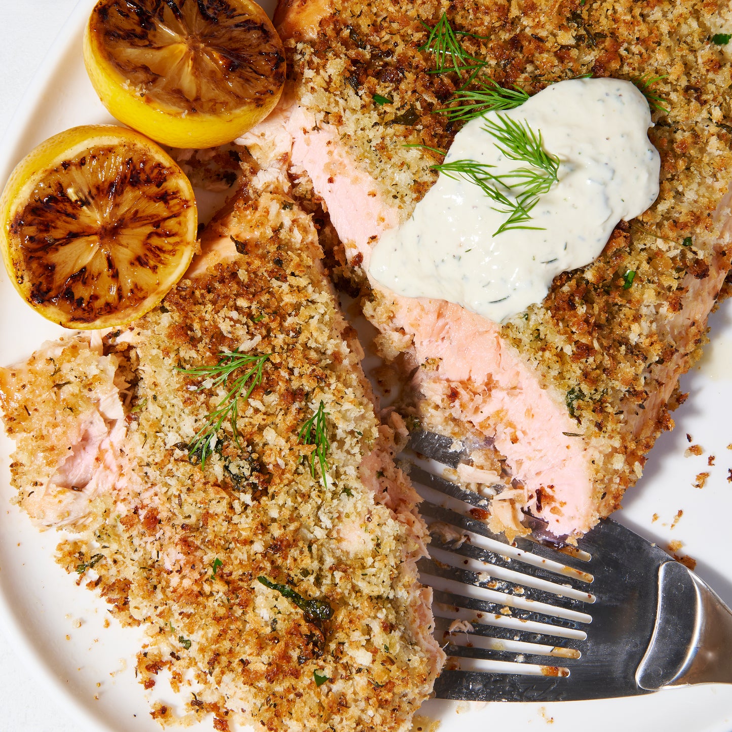 Fennel and herb-crusted salmon with horseradish-dill cream sliced