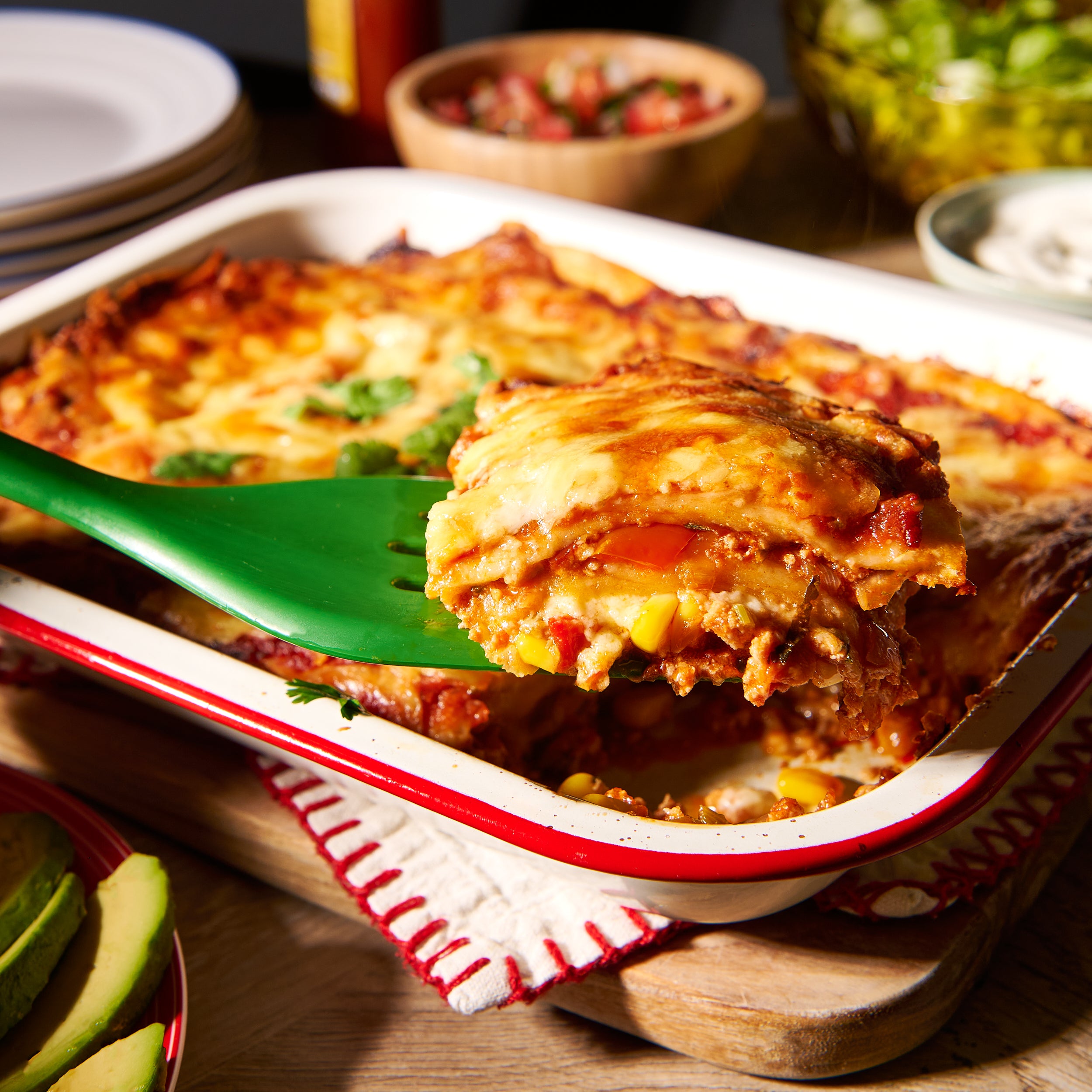 Layered chicken enchiladas with sweet corn and coriander