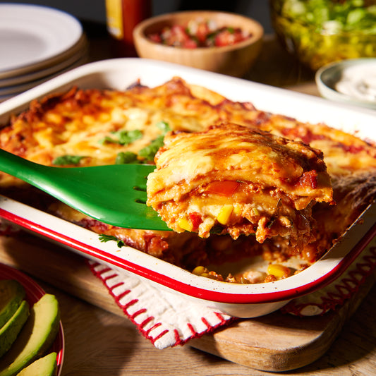 Layered chicken enchiladas with sweet corn and coriander
