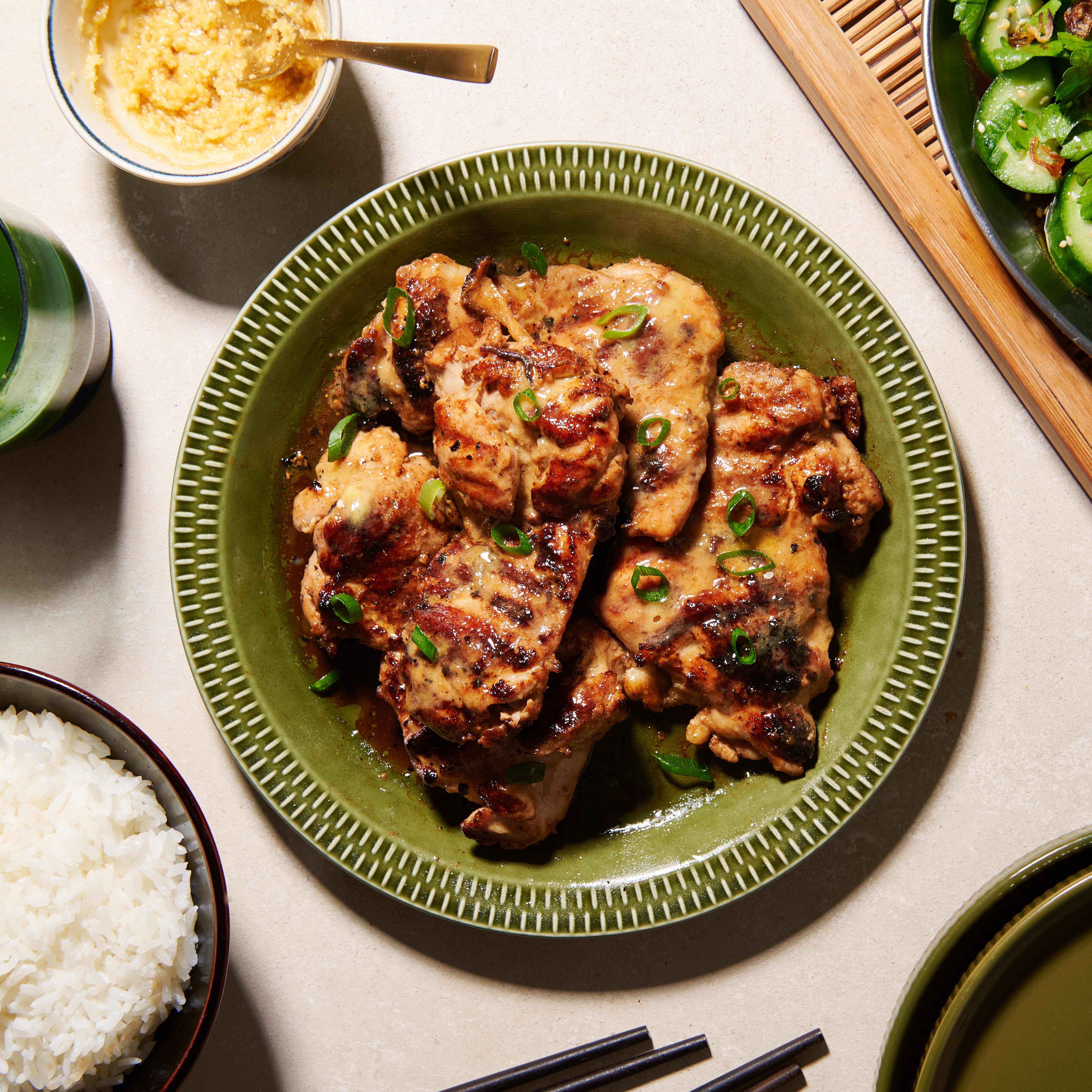 Marinated chicken thighs with miso-maple butter on a plate