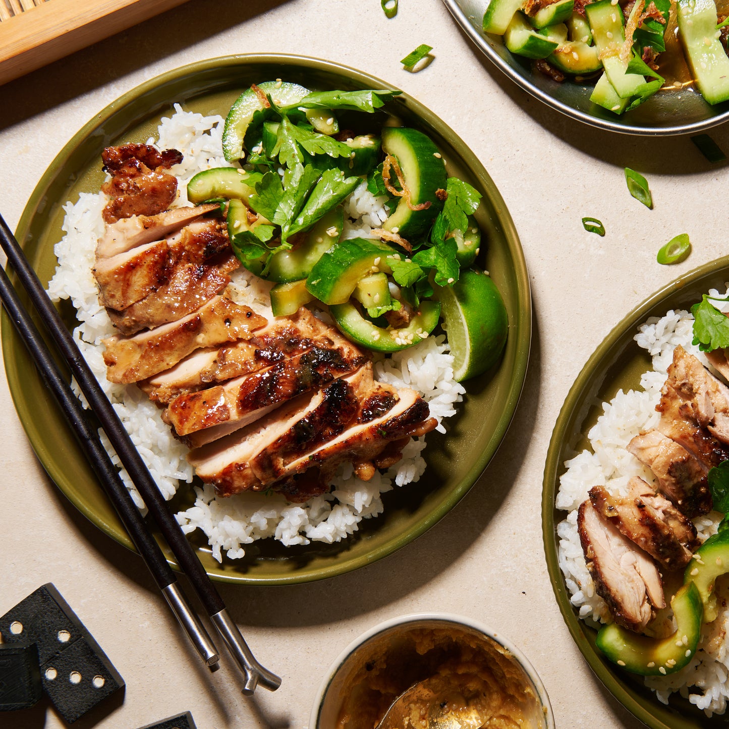 Marinated chicken thighs with miso-maple butter plated with rice and cucumber salad