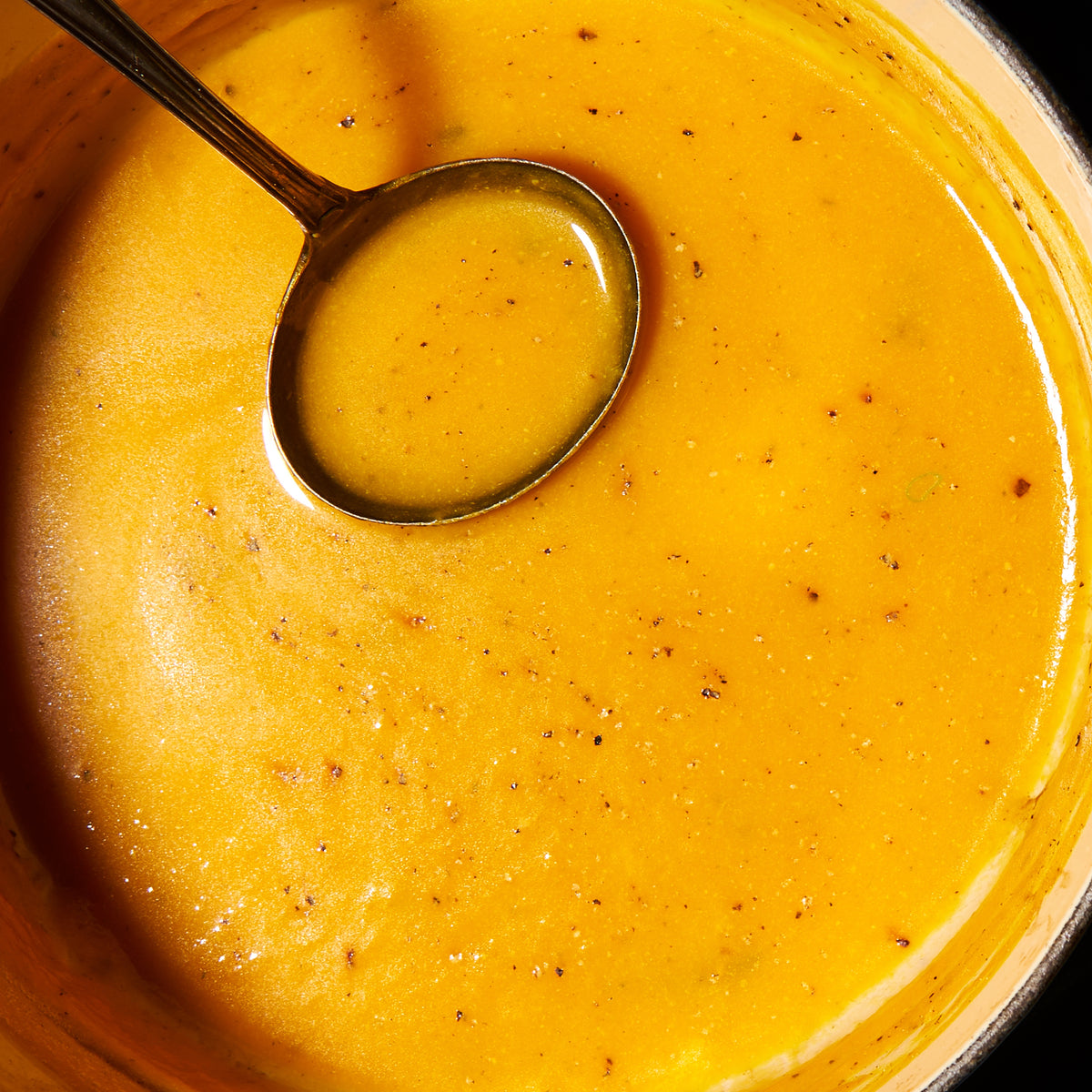 Pumpkin soup with roast garlic and thyme close up