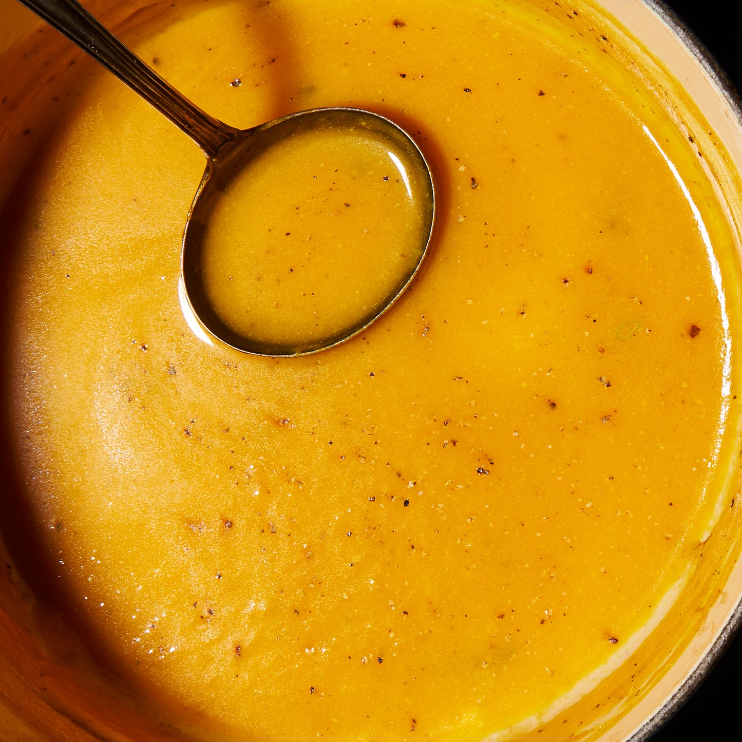 Pumpkin soup with roast garlic and thyme close up