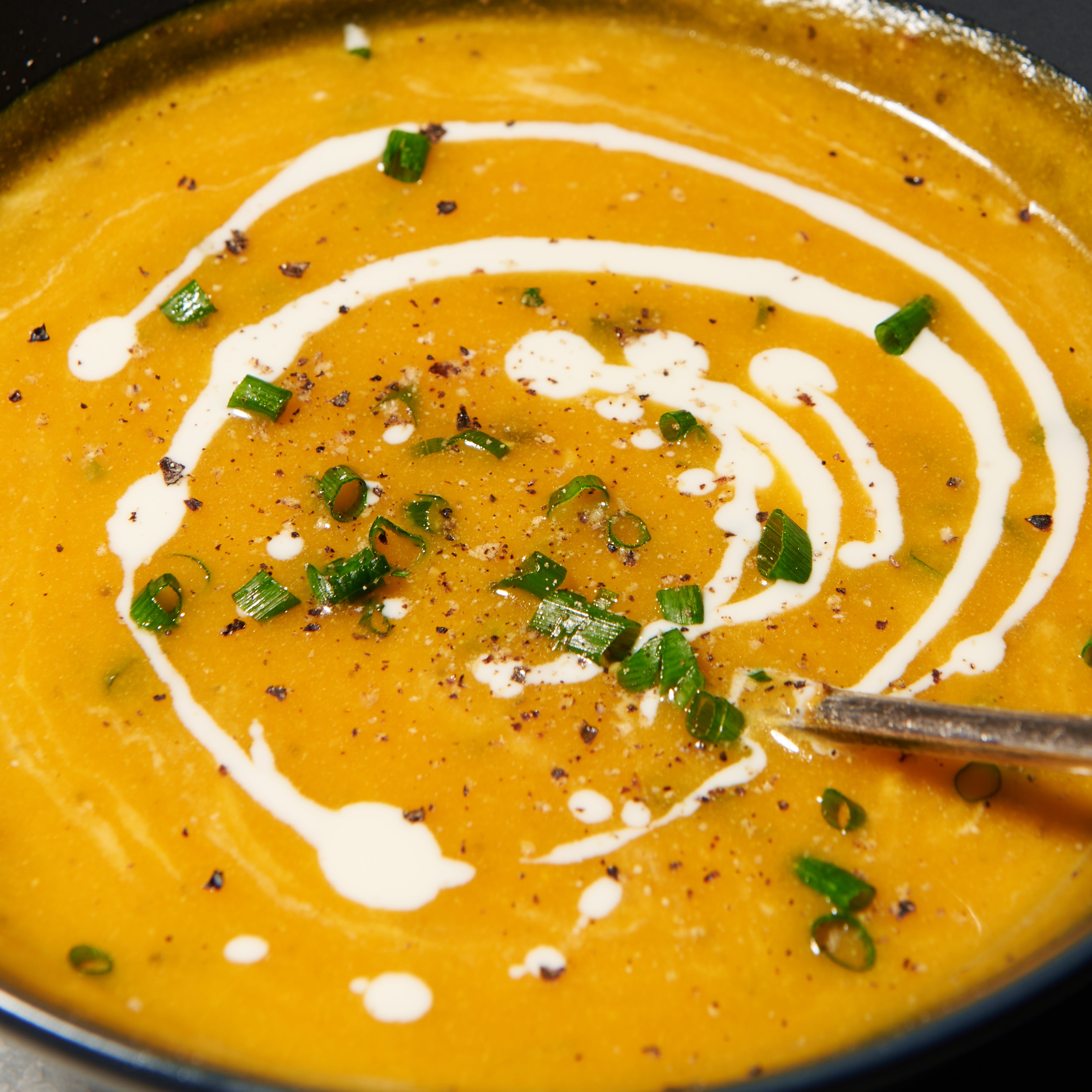 Pumpkin soup with roast garlic and thyme with garnishes
