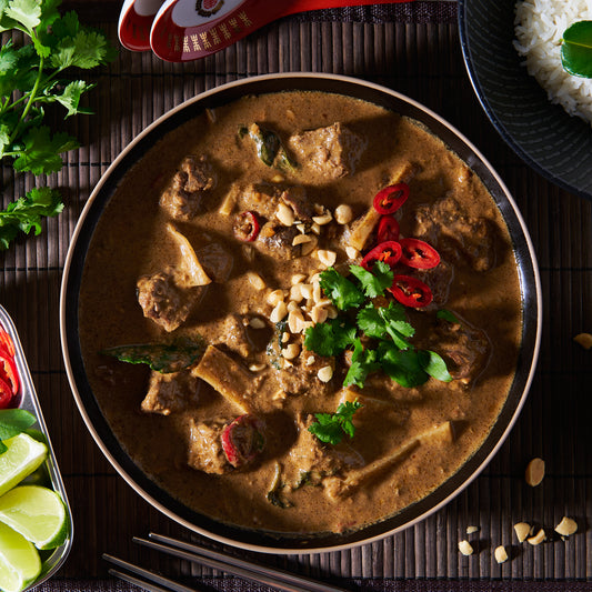 Red curry of beef with bamboo shoots and lime leaves in a bowl
