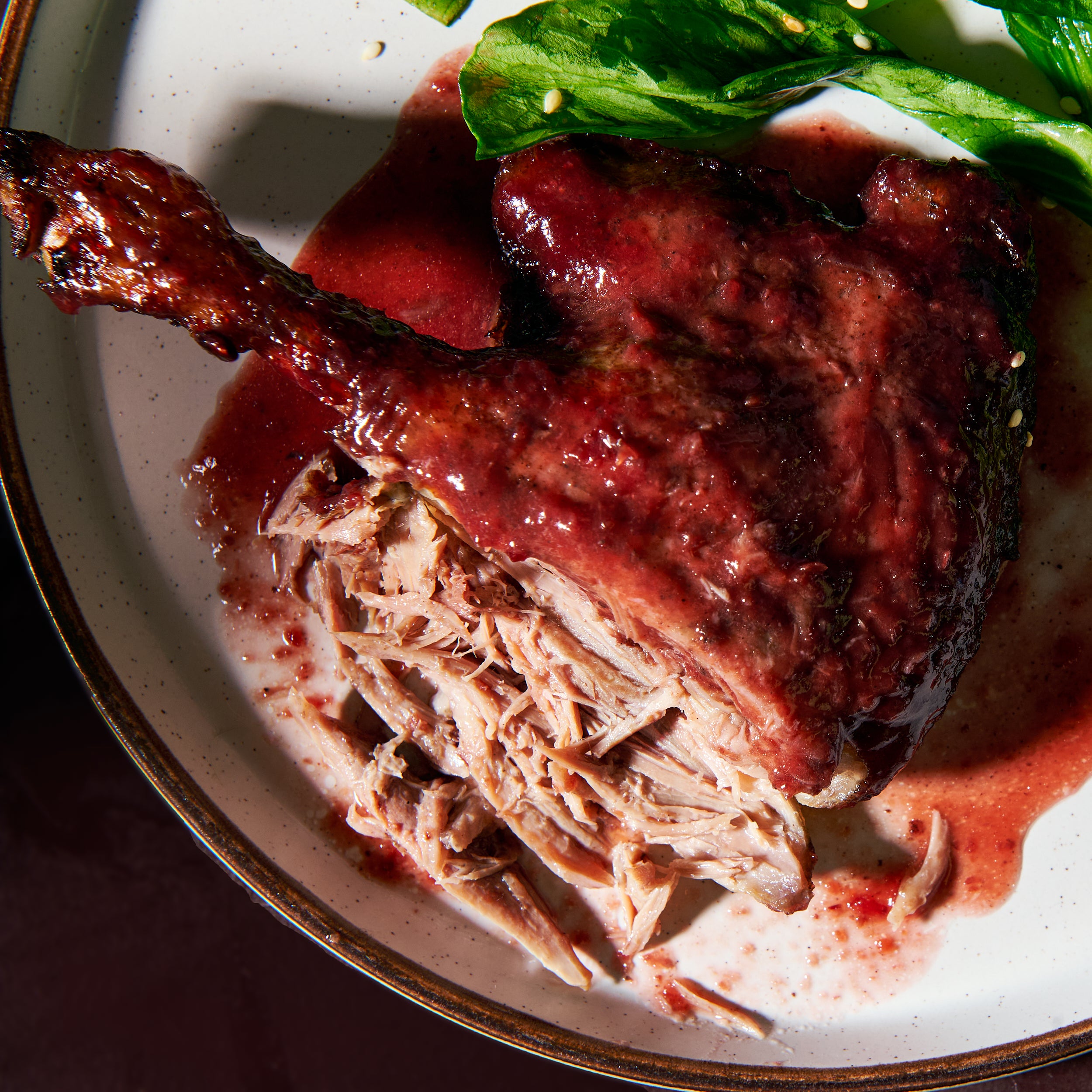 Roast duck marylands with cherry plum sauce close up