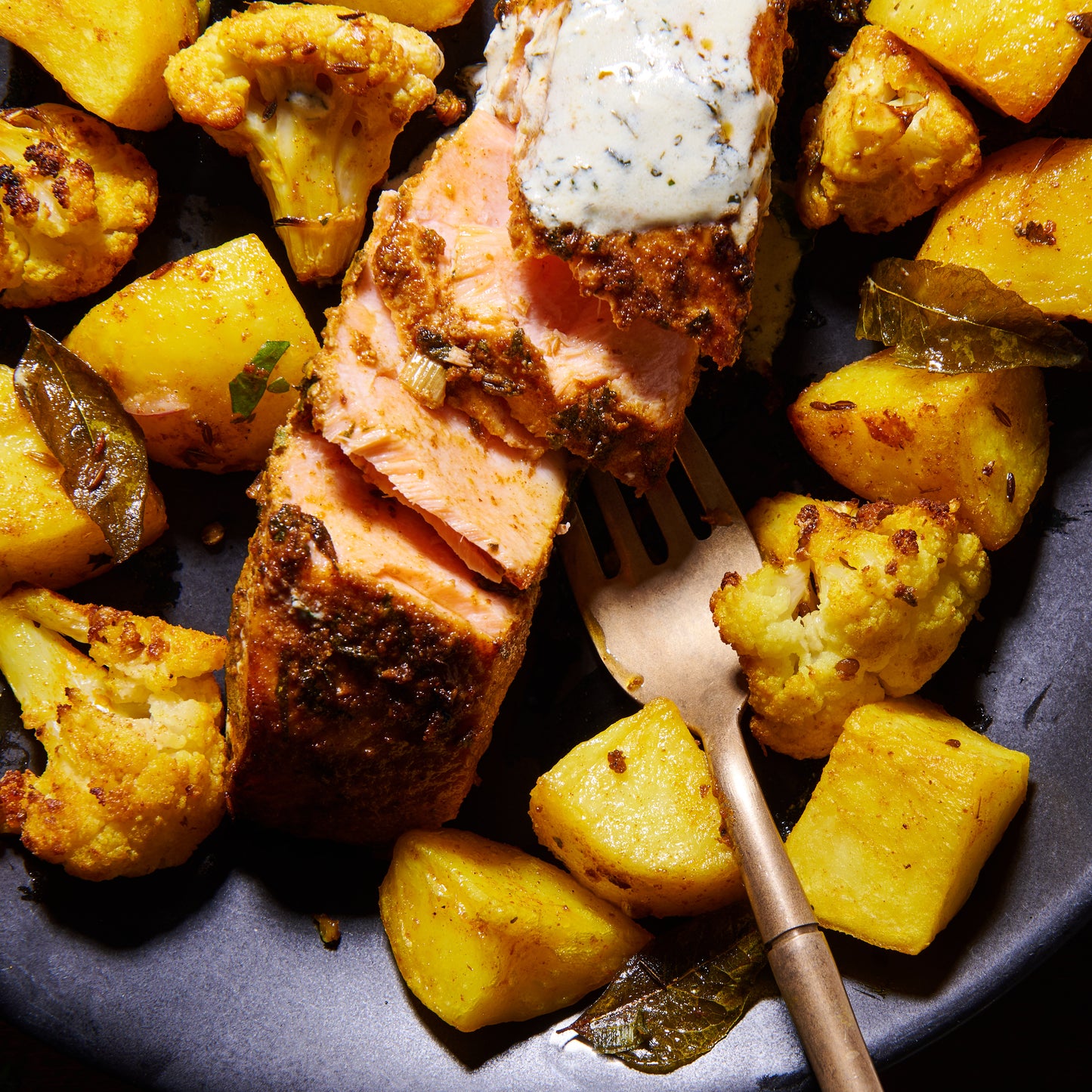 Salmon tikka bowl with turmeric spiced potatoes and cauliflower