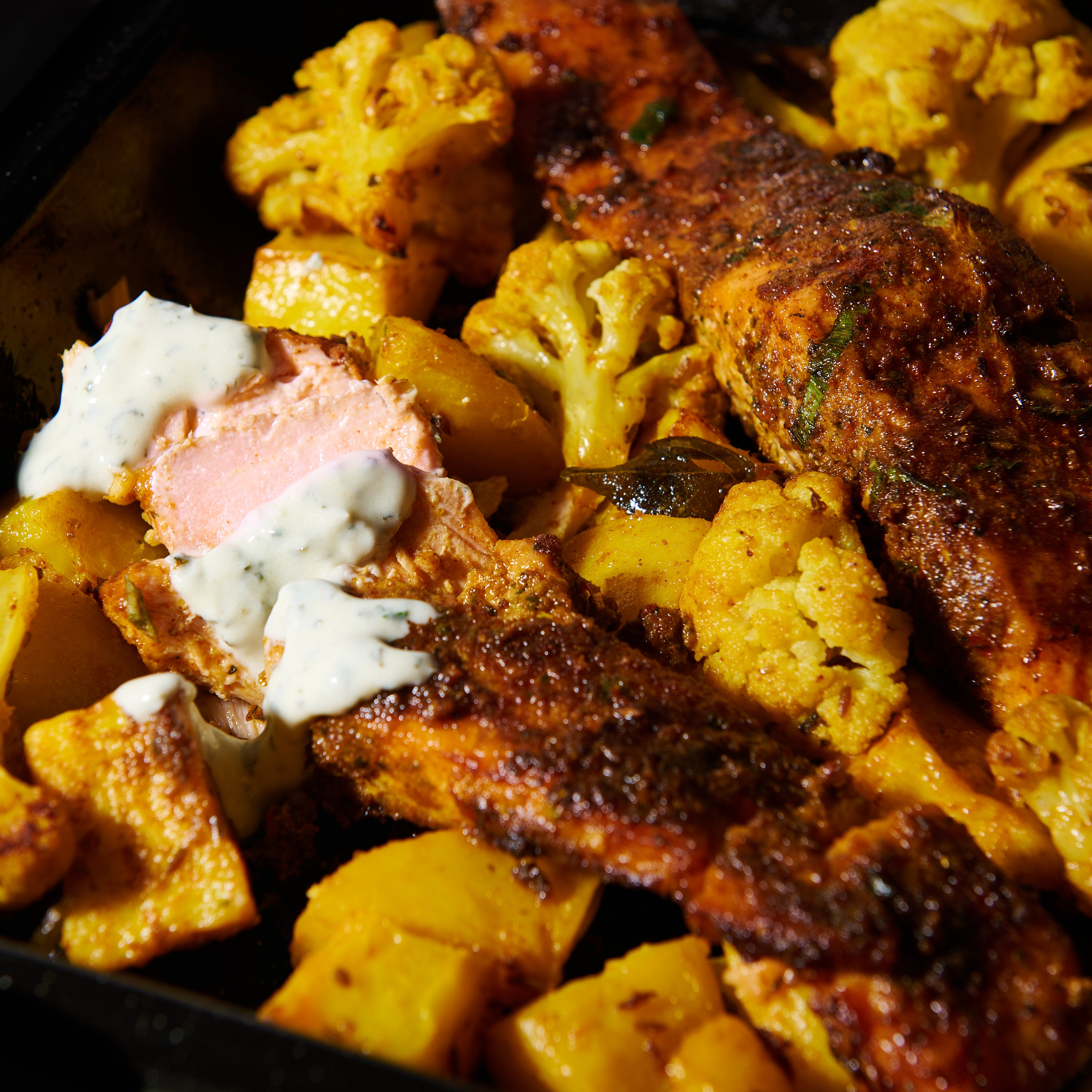 Salmon tikka tray bake with turmeric spiced potatoes and cauliflower
