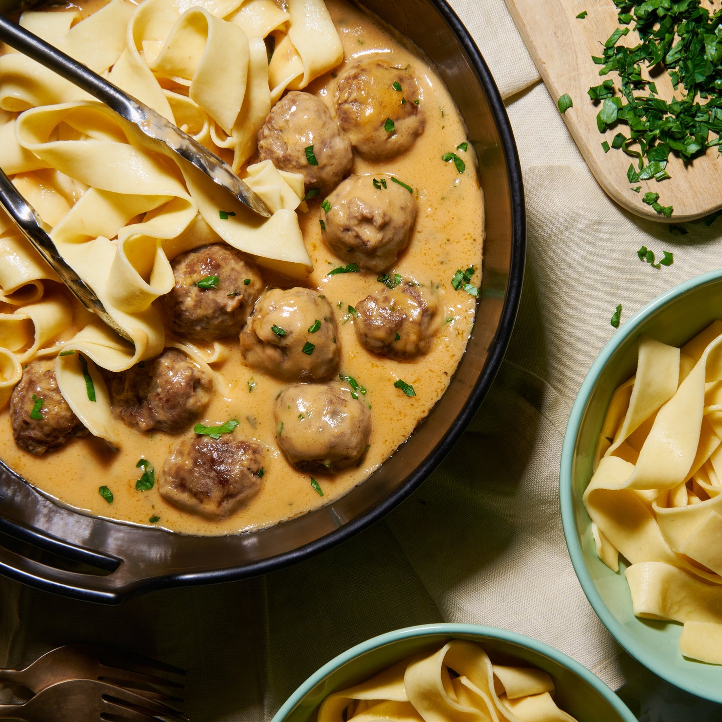 Swedish meatballs in creamy gravy with tagliatelle pasta, ready to be served family-style.
