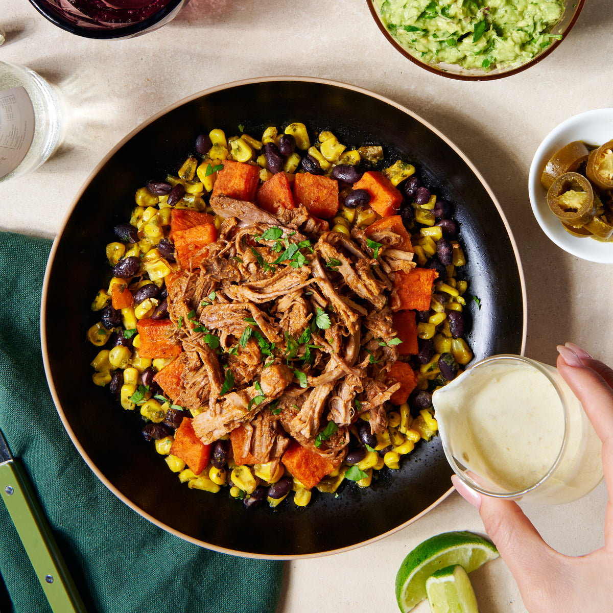 Texan beef with corn, sweet potato and black beans, topped with jalapeño crema and coriander, served in a bowl