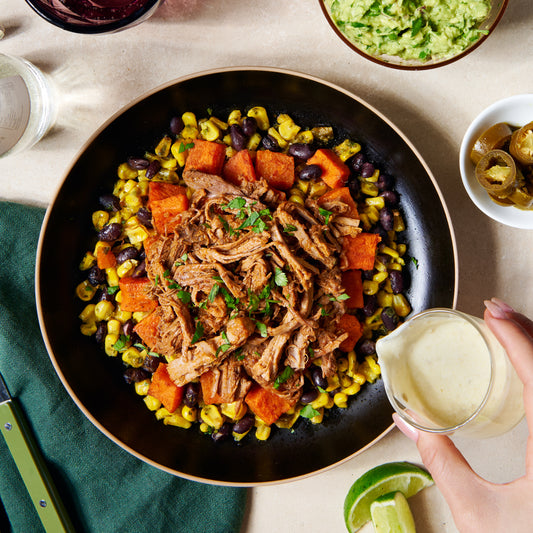 Texan beef with corn, sweet potato and black beans, topped with jalapeño crema and coriander, served in a bowl