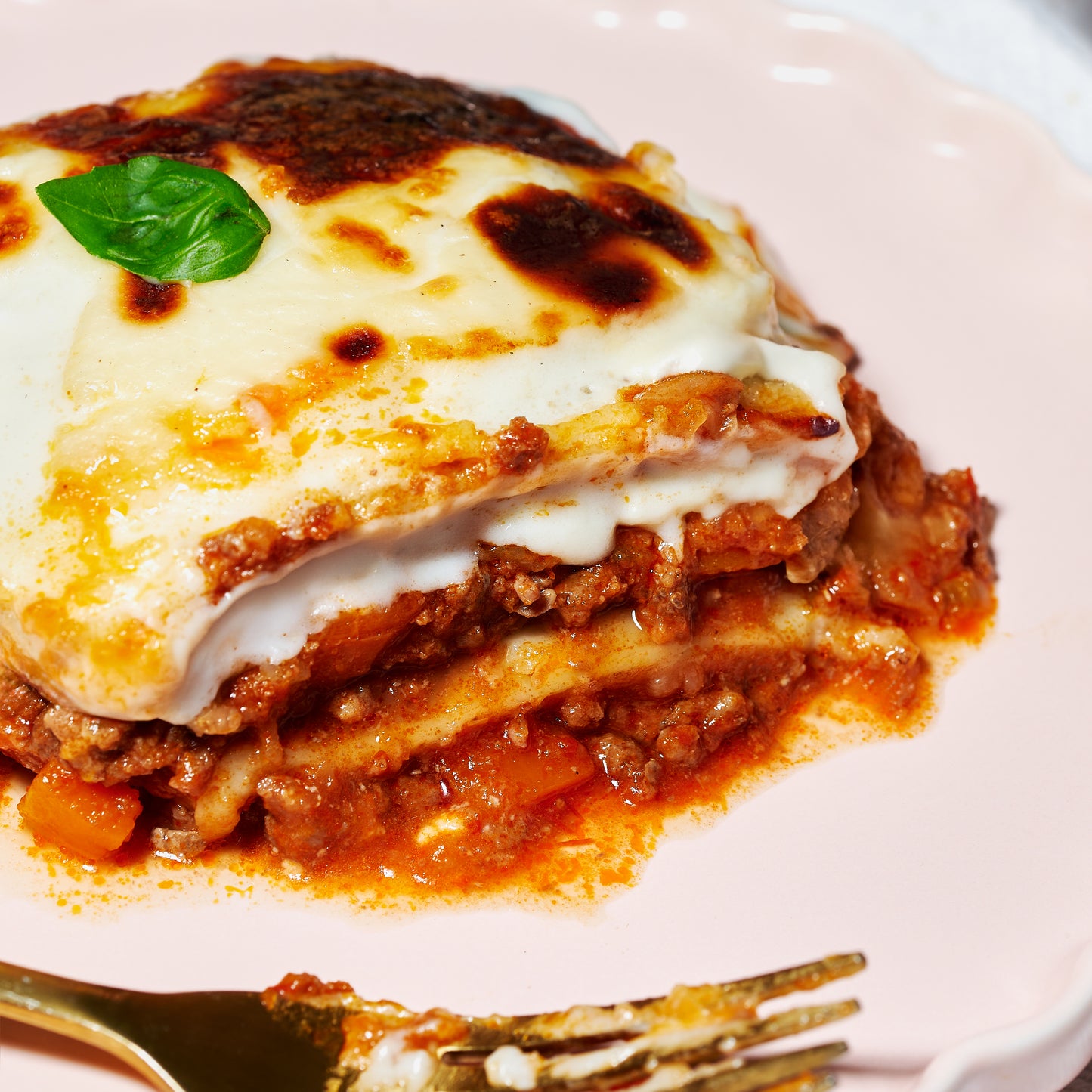 Close up of Classic Beef Lasagne slice with layers of pasta, rich beef ragu and creamy béchamel.