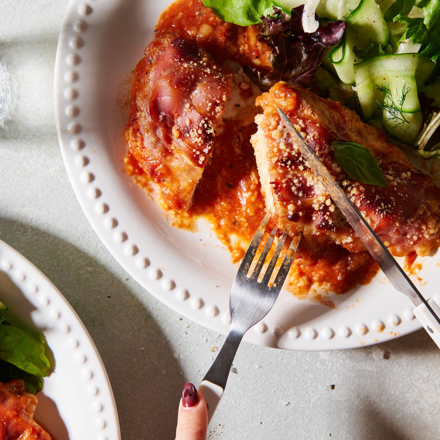 chicken parmigiana on a plate with salad