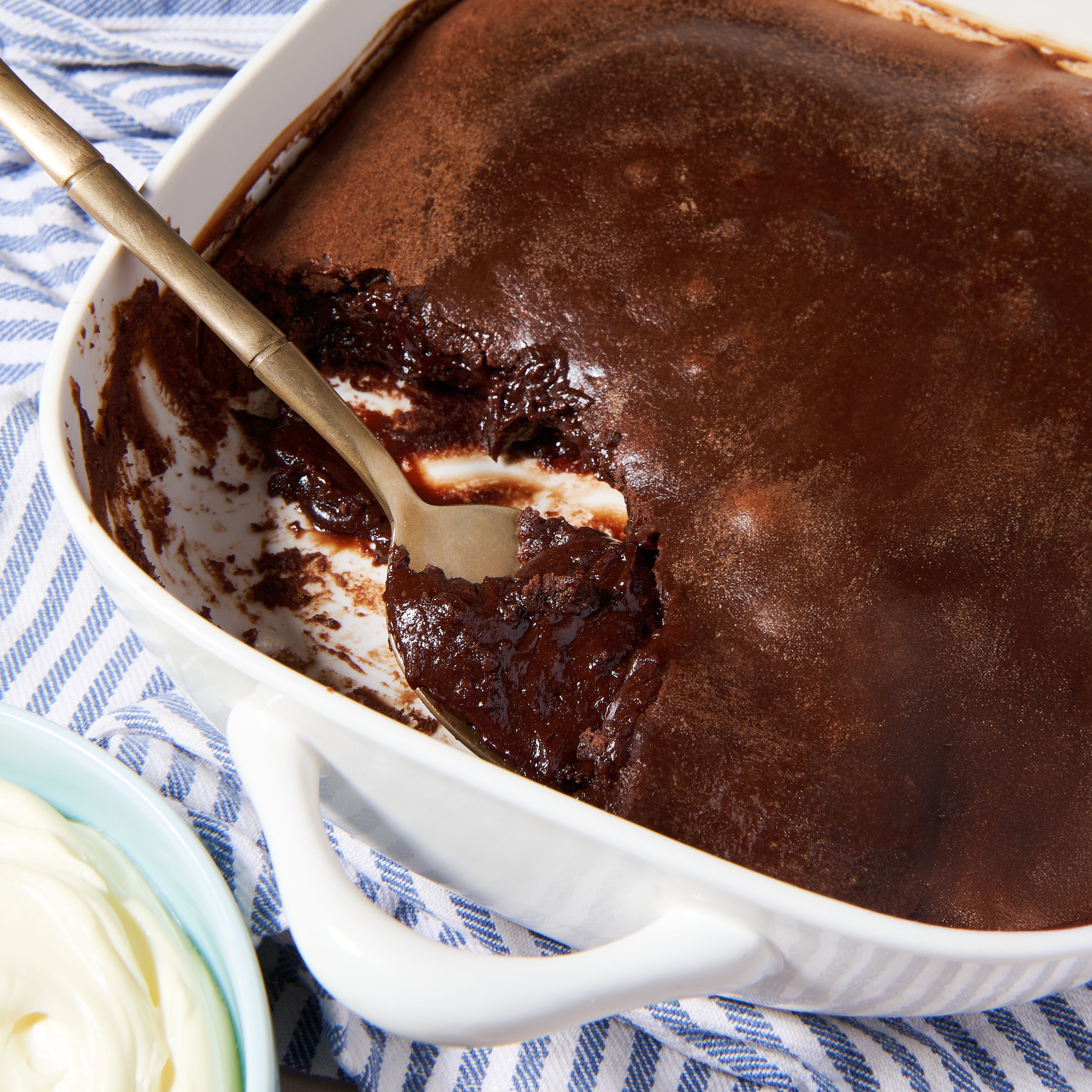 Close-up of molten Belgian chocolate pudding being scooped from a warm lava cake.