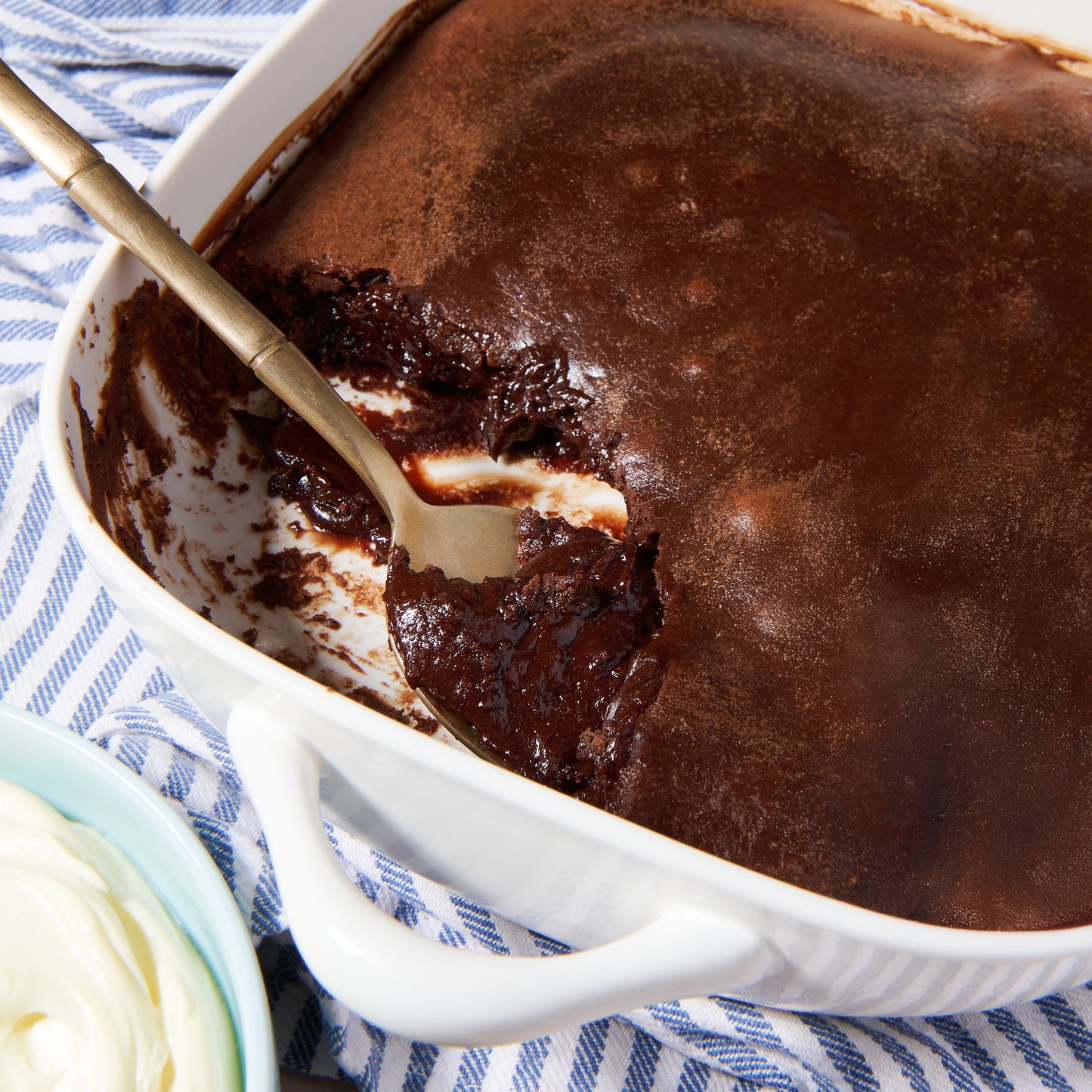 Close-up of molten Belgian chocolate pudding being scooped from a warm lava cake.
