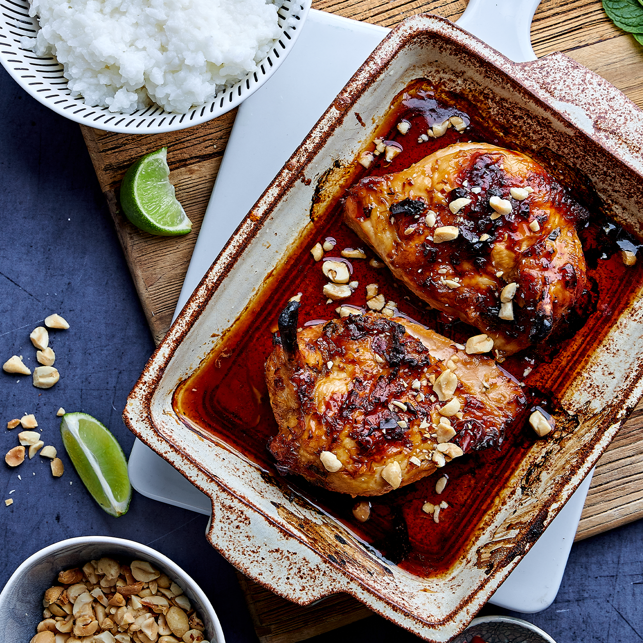 Vietnamese Caramel and Lemongrass Chicken baked in sweet-salty caramel sauce, topped with roasted peanuts, served with lime and rice.